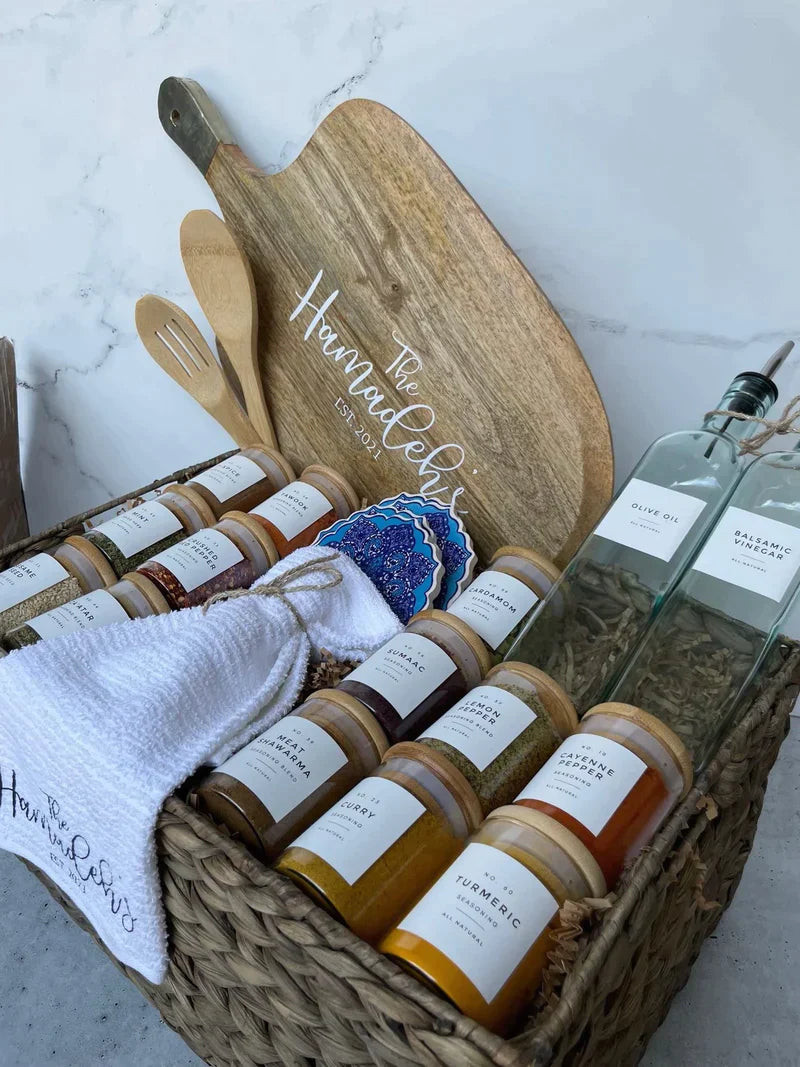 Basket $250 <li> 14 Spices Of Your Choice </li><li> 1 Olive Oil (16 oz) </li><li> 1 Balsamic Vinegar (16 oz) </li><li> 1 Soap Bottle</li><li> Towel </li><li> Large acacia board </li><li> Spoon </li>